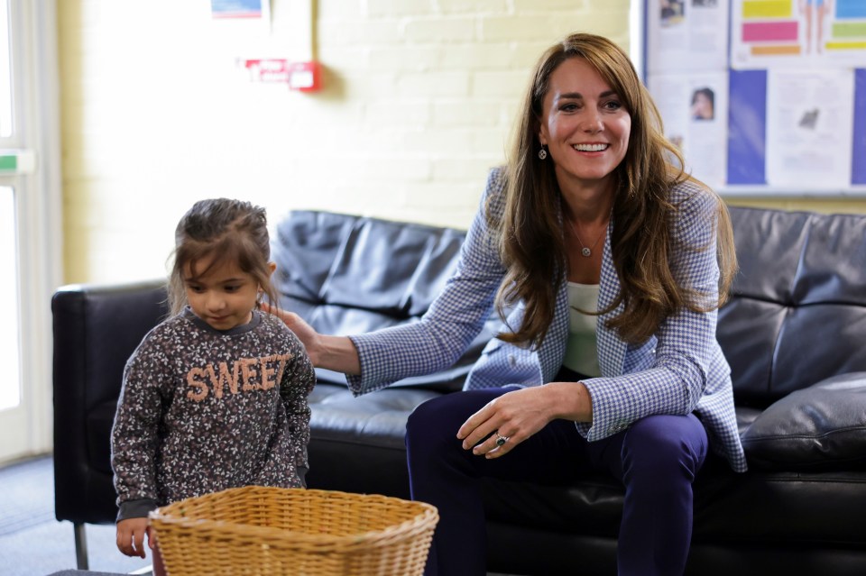 The Princess of Wales meets a little girl on a surprise visit to a family support centre