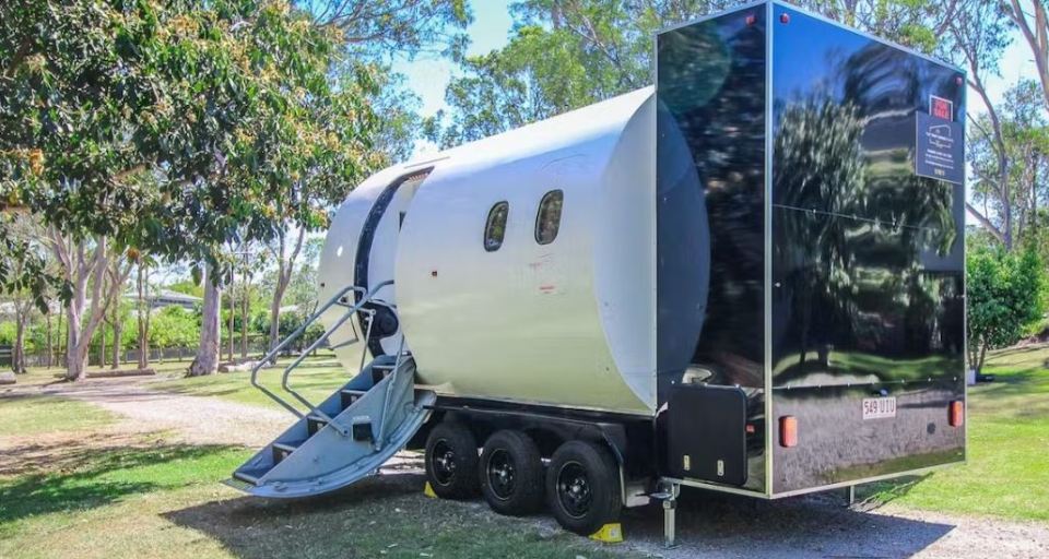 The home is attached to a trailer and has a set of stairs for easy access