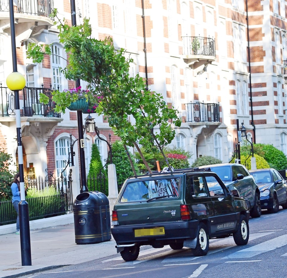 Cooper was seen behind the wheel and the swaying trees in leafy St John’s Wood, north London