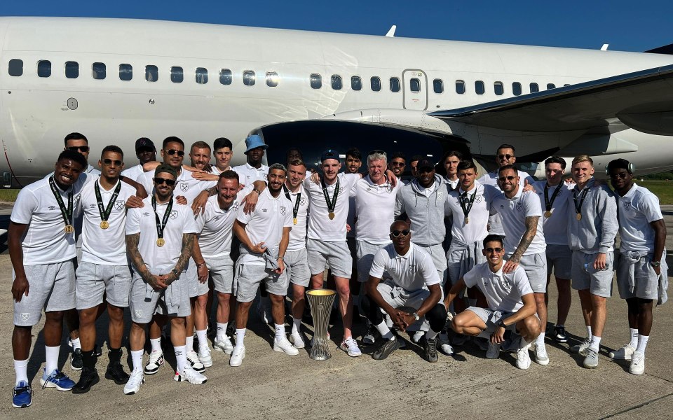 West Ham stars pose with the trophy as they head home