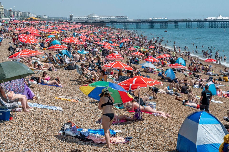 Crowds flock to Brighton beach as temperatures soared to 30C