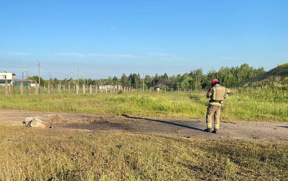 A Russian firefighter inspects the site of the reported crash