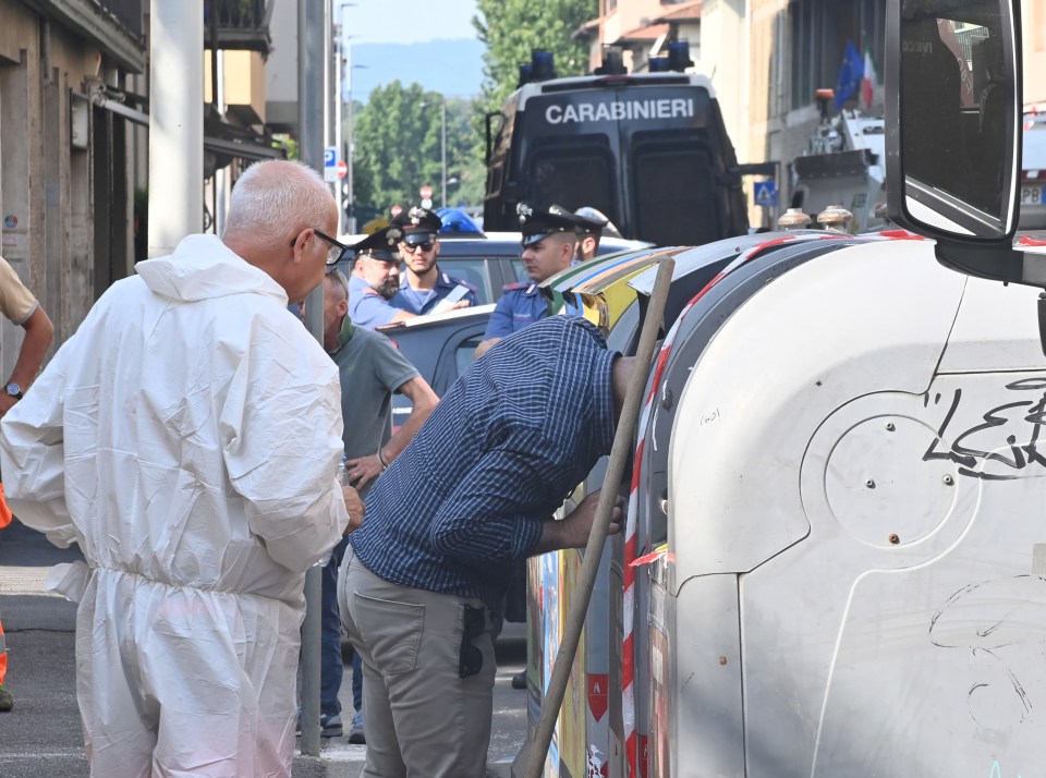 Cops pictured searching bins close to the hotel