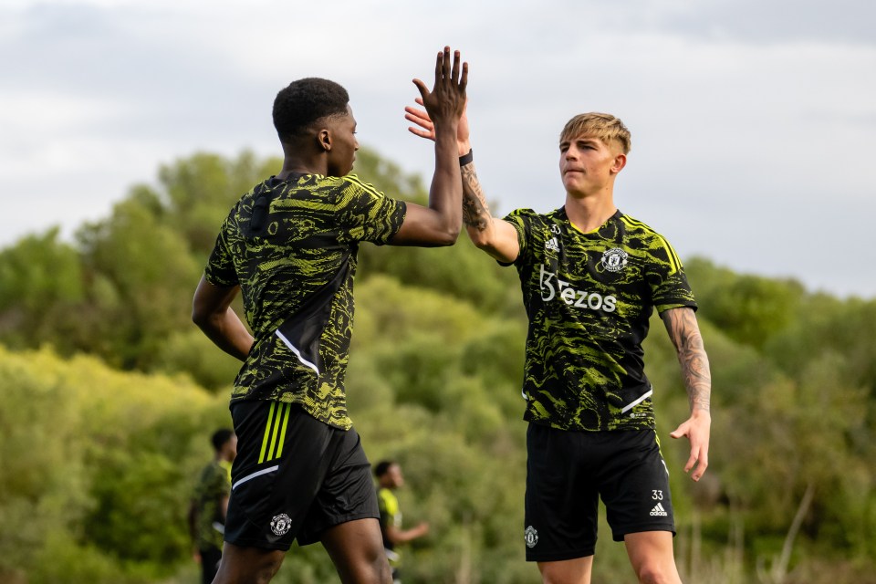 The defender high-fives Brandon Williams in Man United training