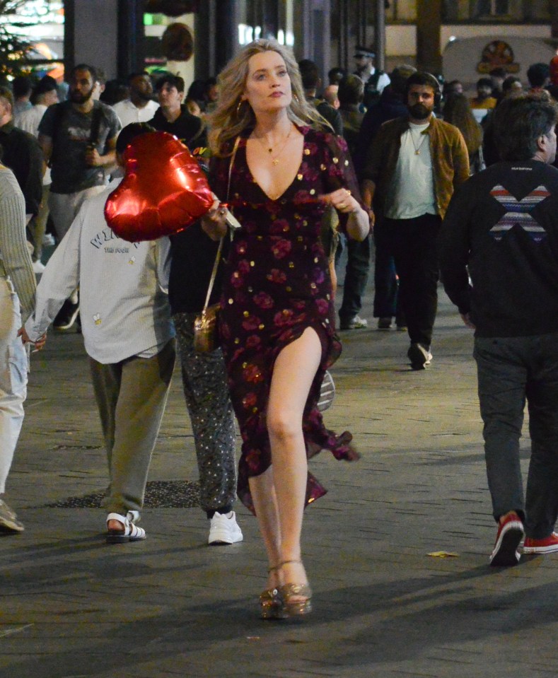 Laura Whitmore looked amazing as she strolled with a red heart-shaped balloon through Soho