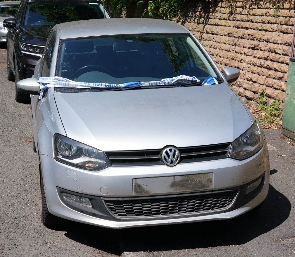 Across the road a silver VW Polo is parked up, its number plates removed, and police tape draped across the windscreen