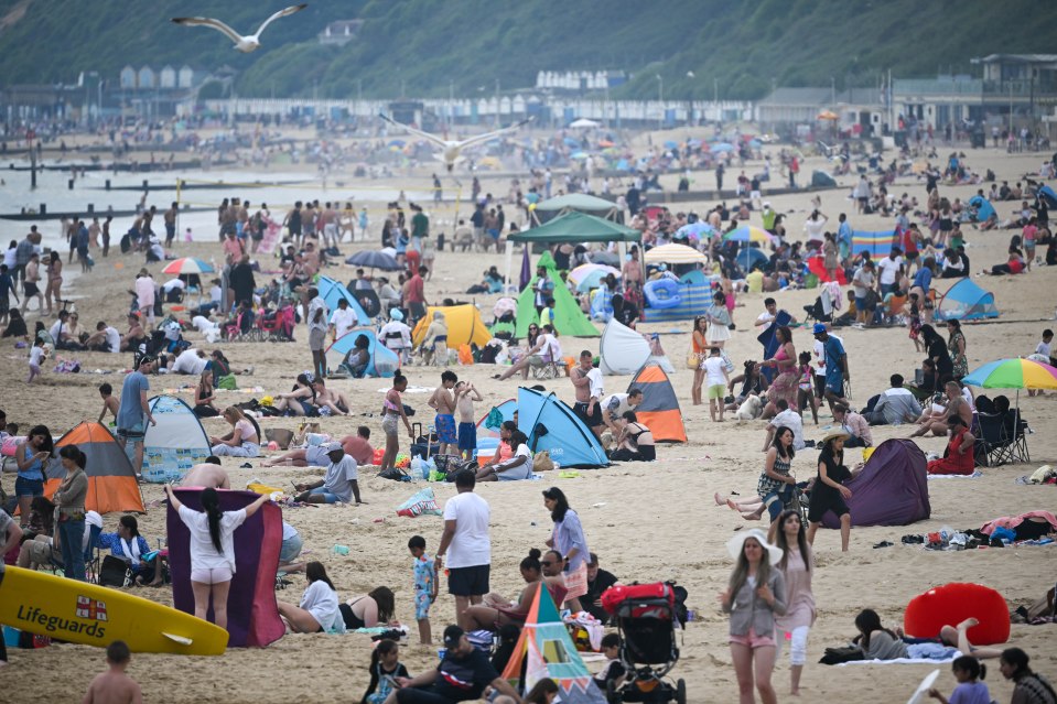 Revellers pack out Bournemouth beach as the UK recorded the hottest day of the year