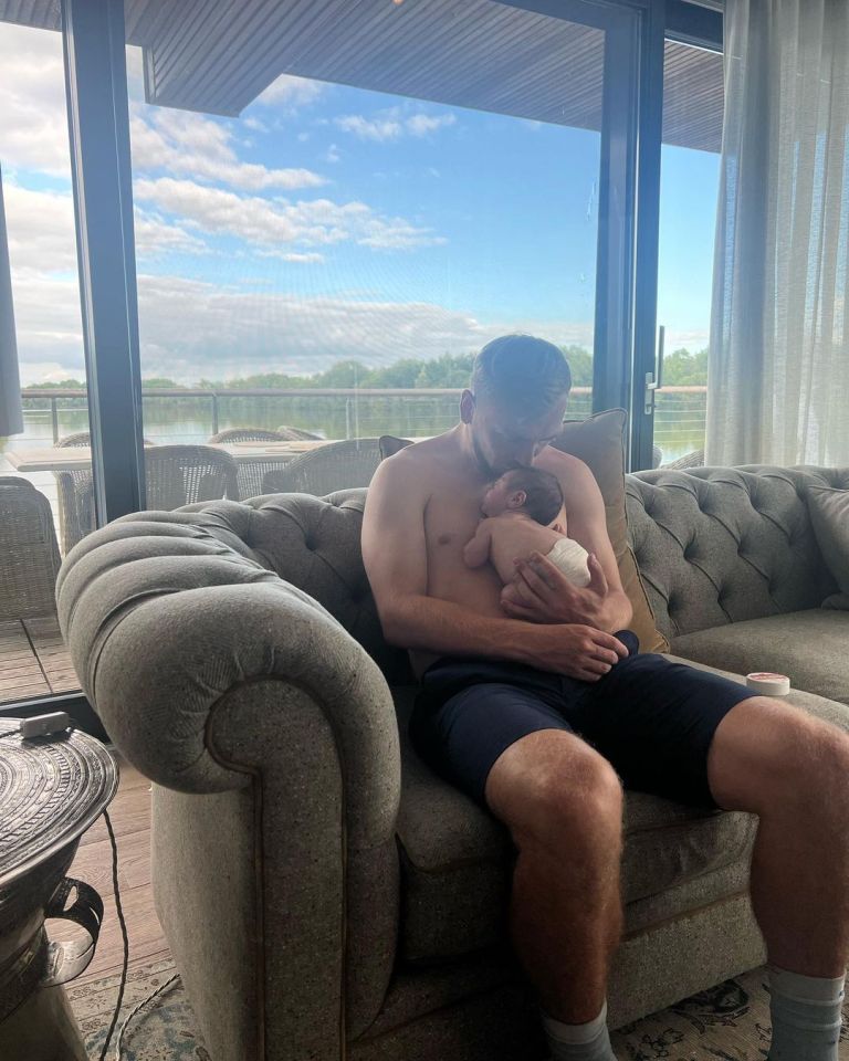 Jarrod cradles his newborn daughter