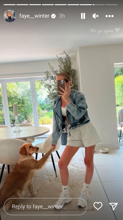 Faye posed in the kitchen with her cute dog