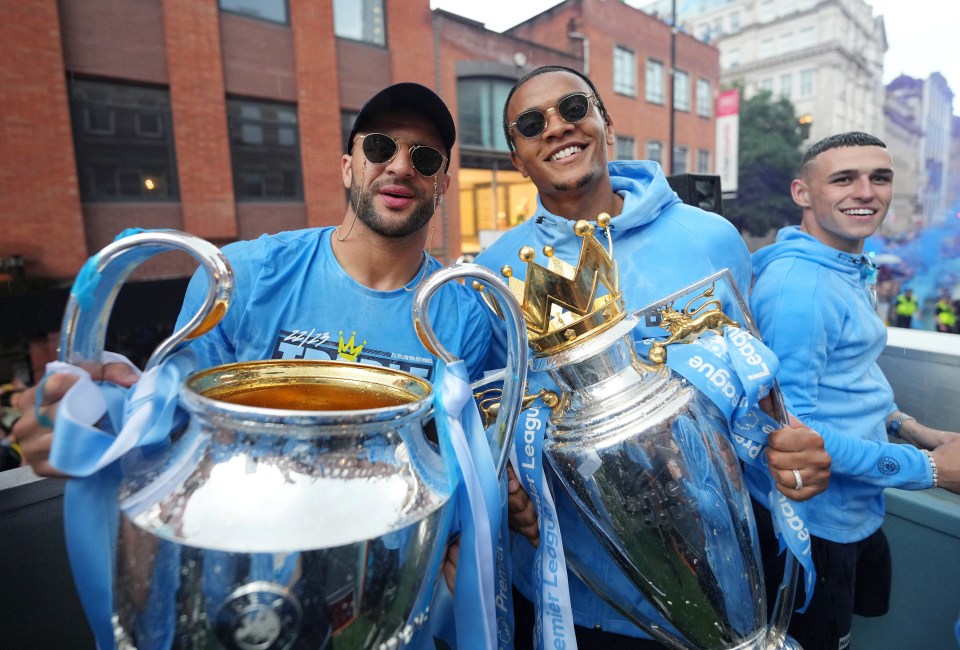 Kyle Walker and Manuel Akanji with the Champions League and Premier League trophies