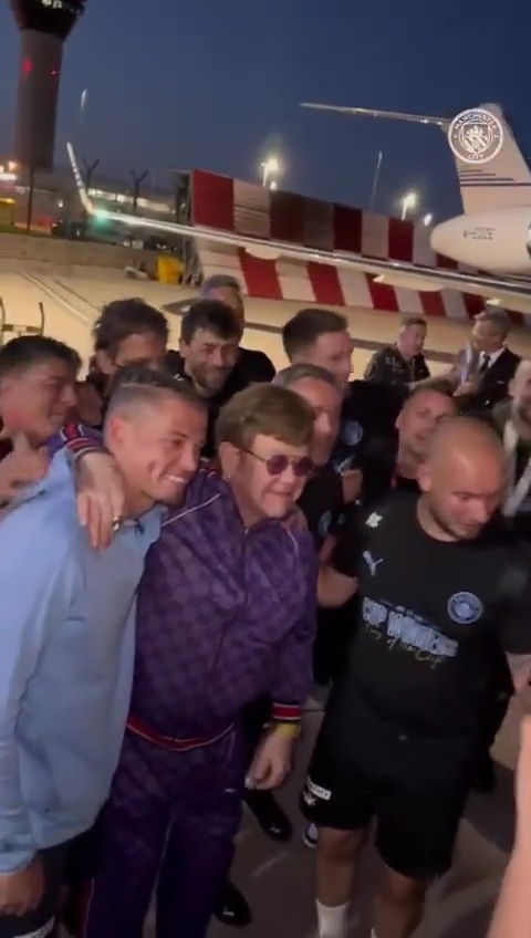 Man City's staff then serenaded an posed with Elton John