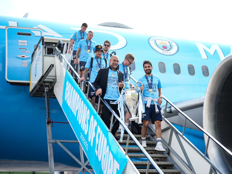 Heroes Pep Guardiola and Ilkay Gundogan arrive back home with the Cup