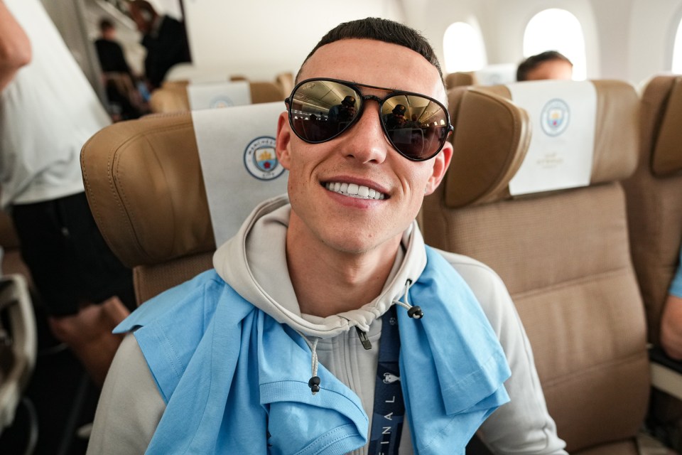 Local lad Phil Foden could not stop smiling on the plane