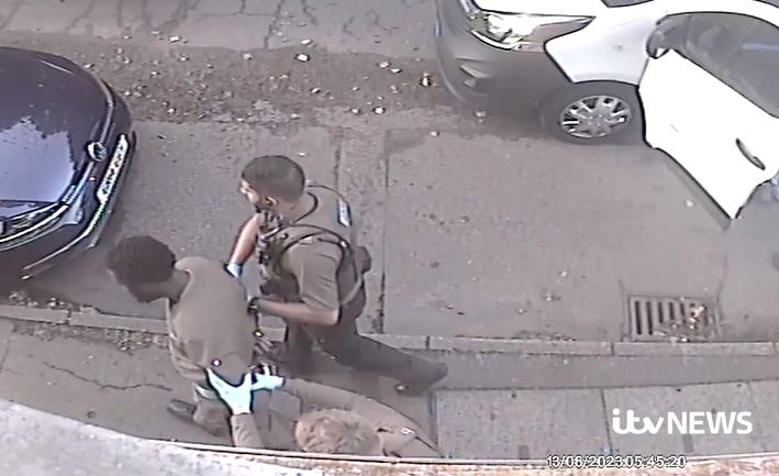 New CCTV footage shows the man handcuffed and taken away by cops nearby a white van