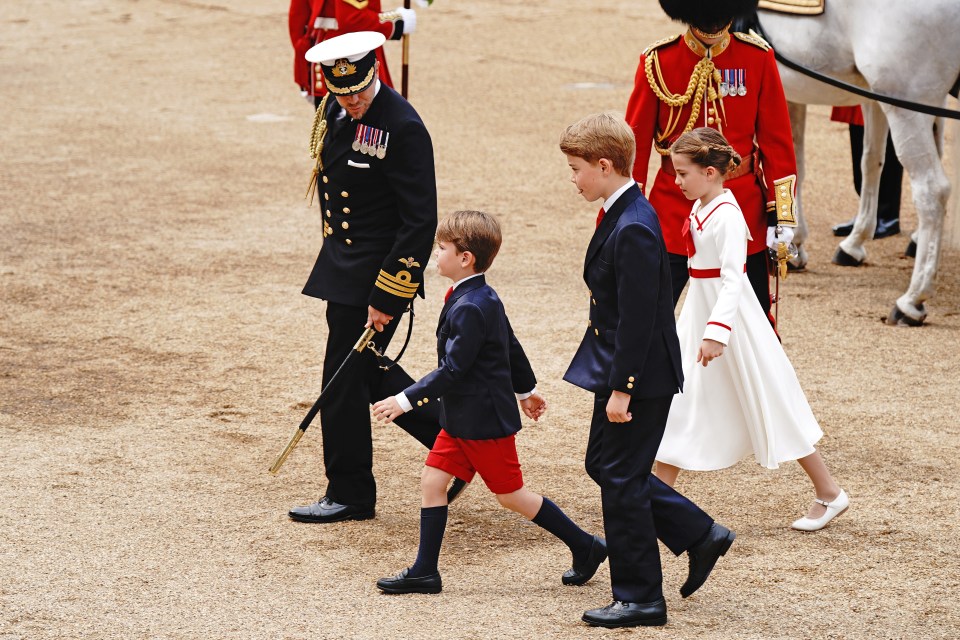 The young royals are dressed in blue, red and white, with mum Kate wearing green