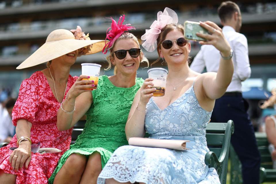 A trio of pals in sunglasses cosied up for a selfie at Royal Ascot