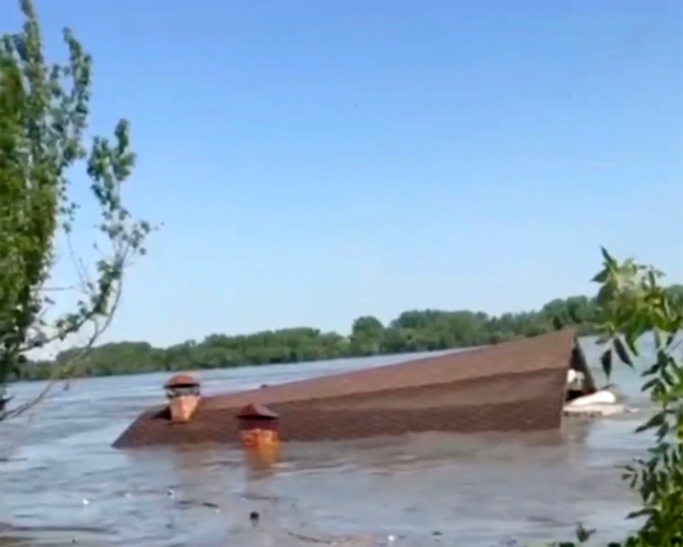 One house appears to be swept away in the flood waters