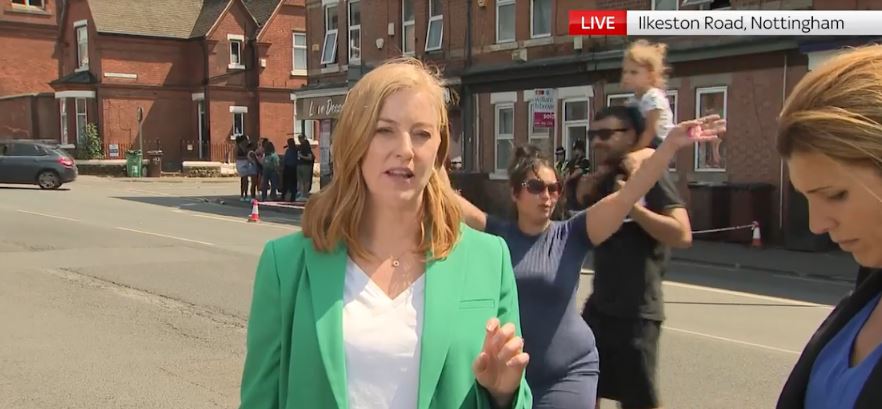 Another man grinned as he held a toddler on his shoulders before walking into frame behind the newsreader