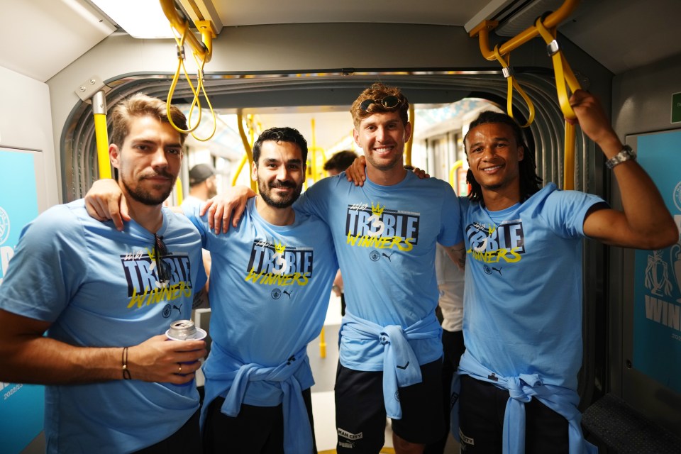 (L-R) Stefano Ortega, Ilkay Gundogan, Stones and Nathan Ake on the tram