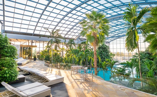 An indoor beach with palm trees and sun loungers will be part of the facility