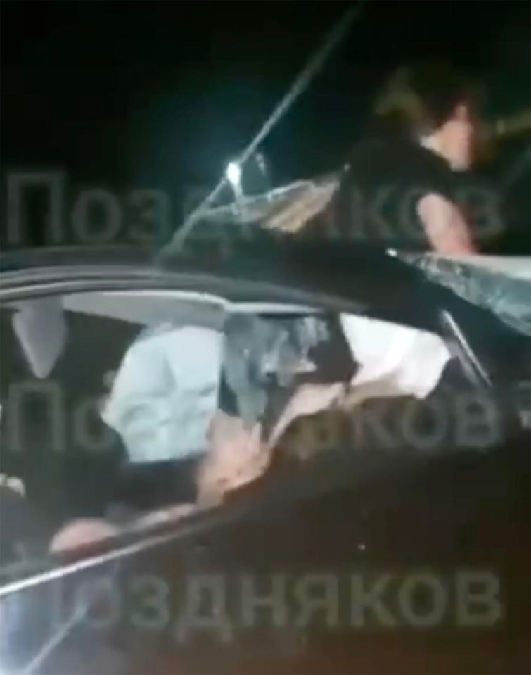 Video shows a wounded woman in a black vehicle being aided by motorists