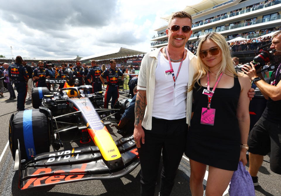 Holly flashed her toned legs in a black minidress at the British Grand Prix