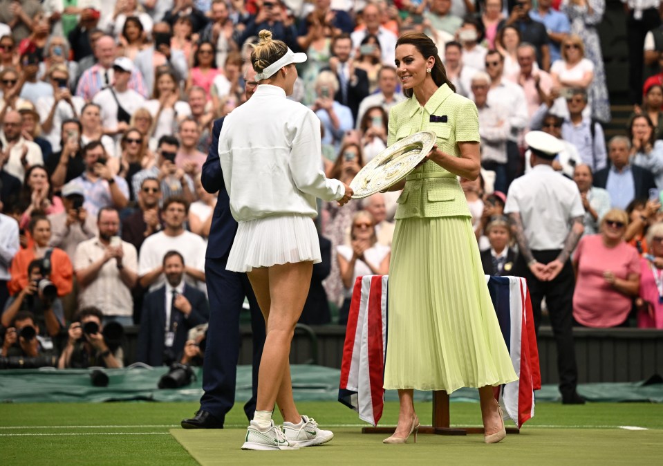 Vondrousova receives the trophy from the Princess of Wales after winning the final