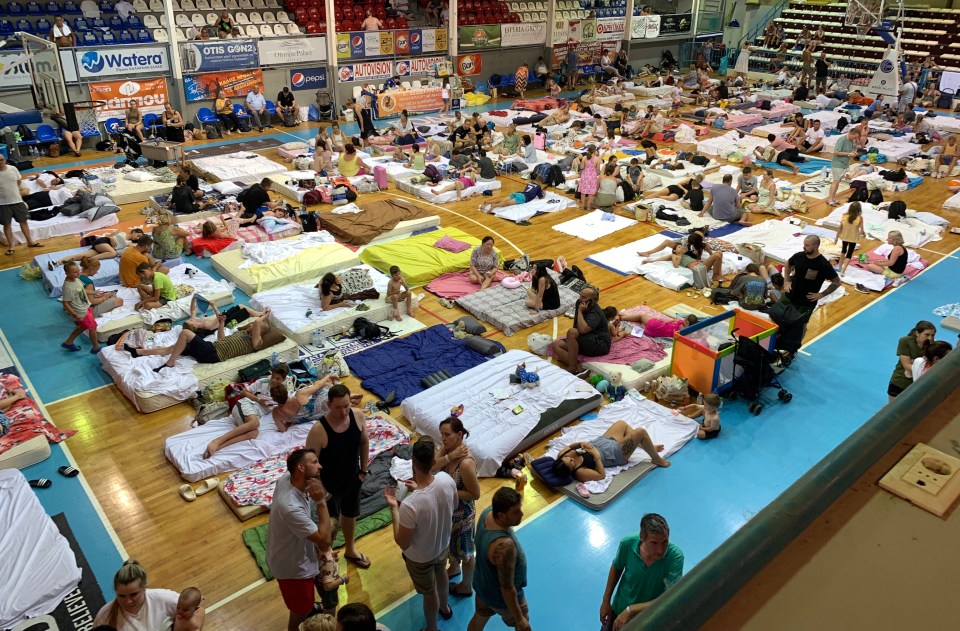 Stranded holidaymakers seen sleeping on the floor in gyms and schools