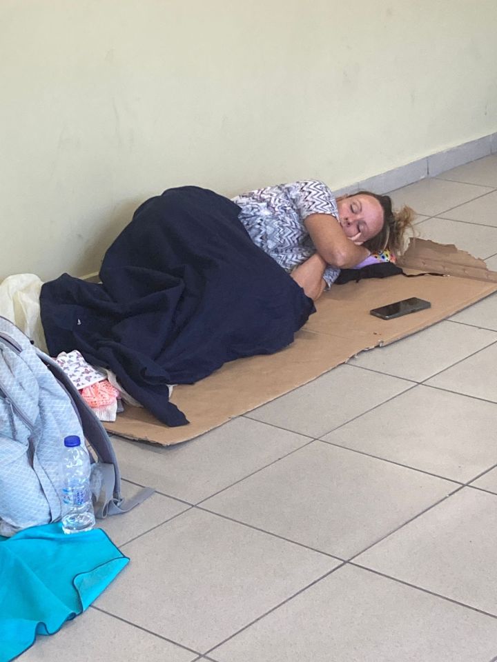 Holidaymaker pictured sleeping on the floor after flying in from Manchester despite the unprecedented crisis