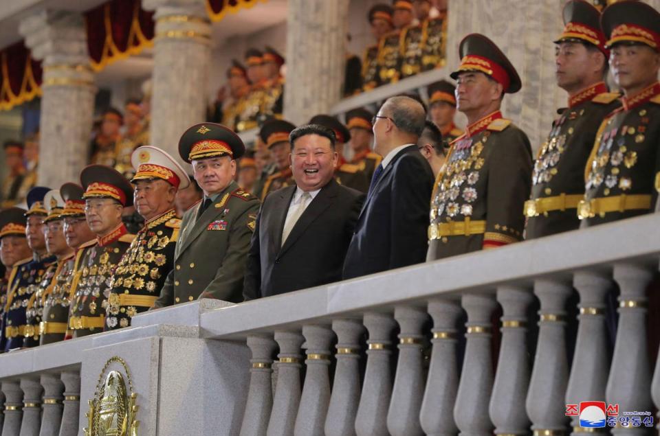 The despot laughed as he chatted with officials