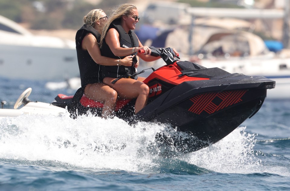 She let her hair down as she whizzed around on a jet ski with a pal on the back