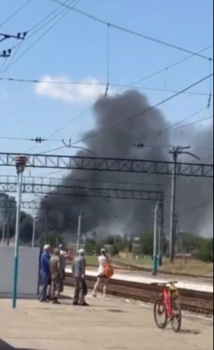 Locals stare in shock and horror as heavy black smoke fills the air