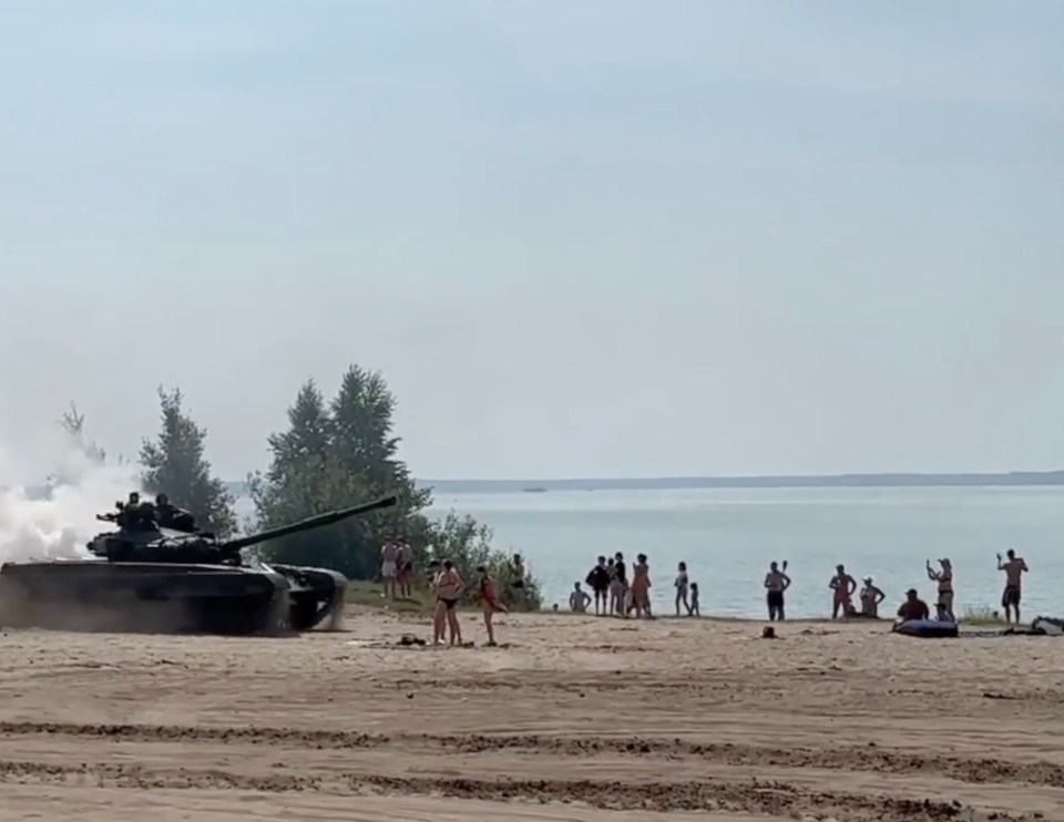 Footage shows the tank rolling onto a busy beach