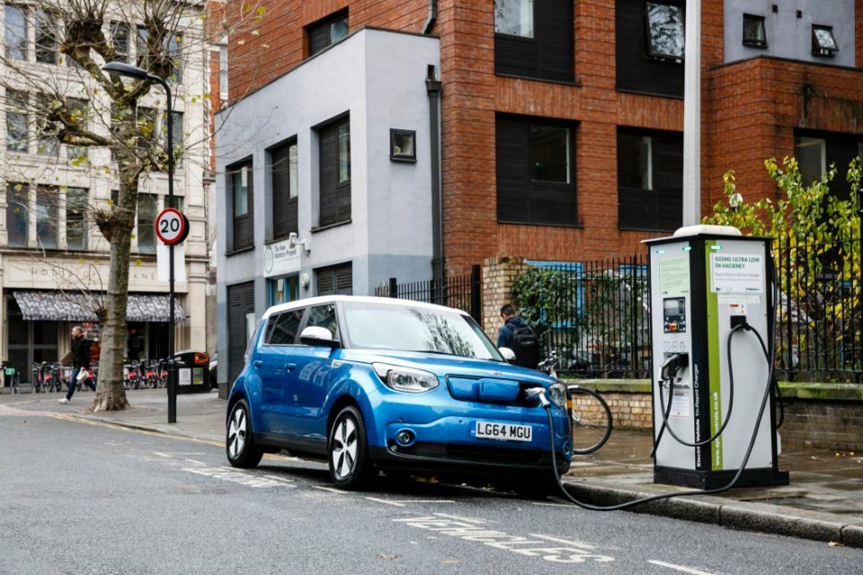 Go Ultra Low Kia Soul EV on charge on a London street. Ultra-low emission vehicles such as this can cost as little as 2p per mile to run and some electric cars and vans have a range of up to 700 miles.