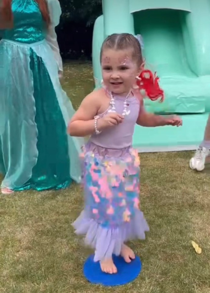 The little one was seen jumping for joy in front of a bouncy castle