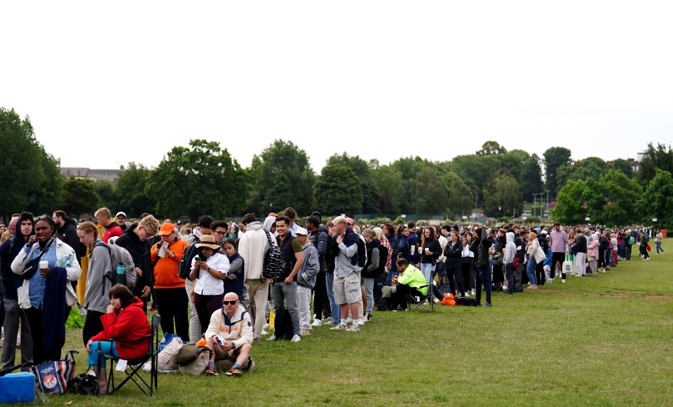 Tennis fans in the queue on Wimbledon's day two were braced for more lengthy - and rainy waits - after officials fearing eco-protests ramped up security checks