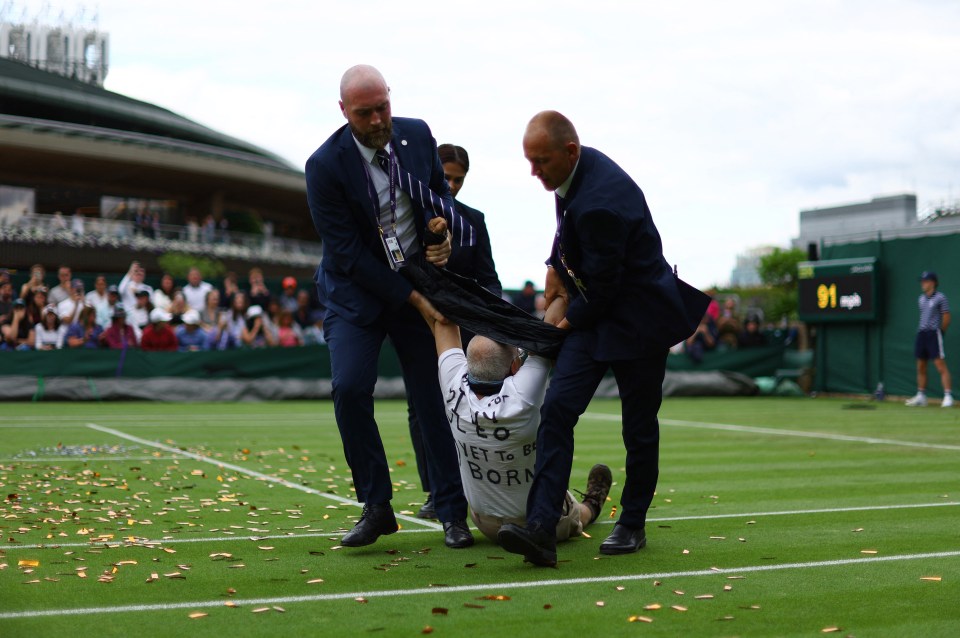 One man was seen rushing across the court before being dragged off at around 4.30pm