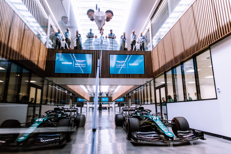 Lance Stroll takes his Aston Martin racing car through the building