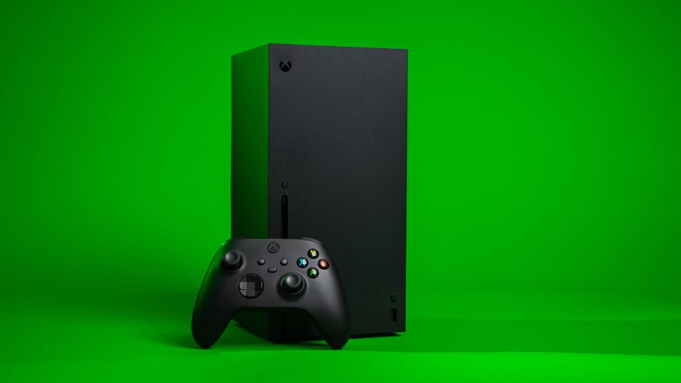 a black xbox box with a black controller on a green background