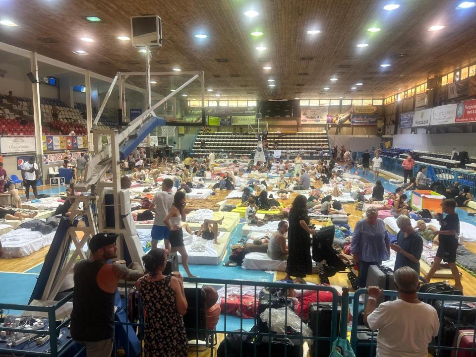 Pictures show tourists sleeping on mattresses in school gyms after the evacuation