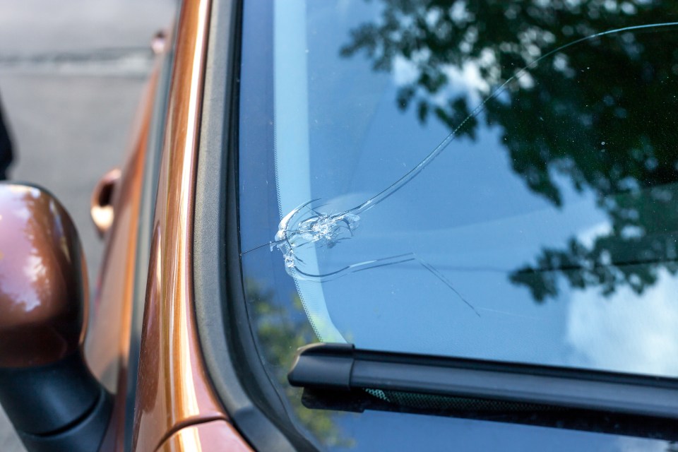 a close up of a broken windshield on a car