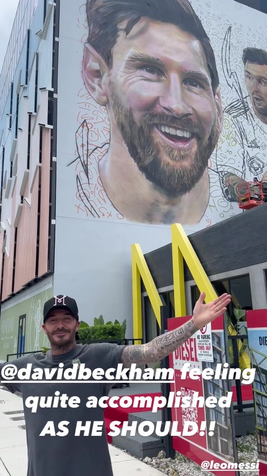 The Man Utd legend stands below his work of art