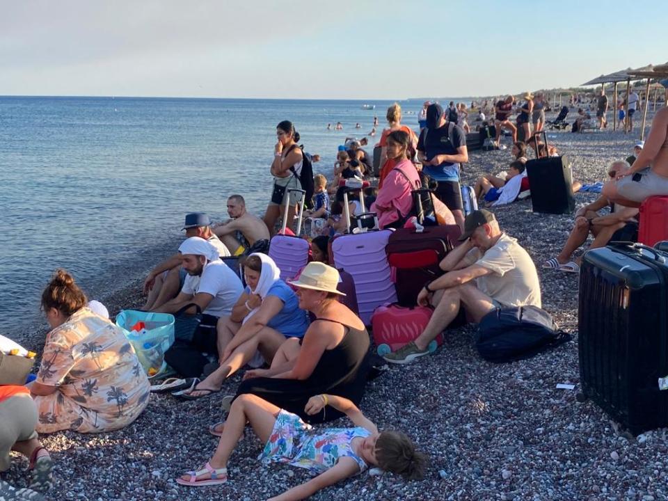 Tourists like Toby and Louise's family fled to the sea with their luggage to escape the inferno