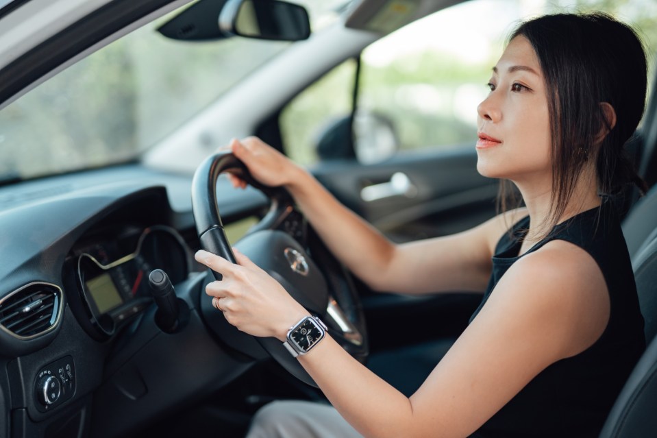 Young beautiful businesswoman driving a car while going on business trip. Business travel. Car Insurance. Car rental.