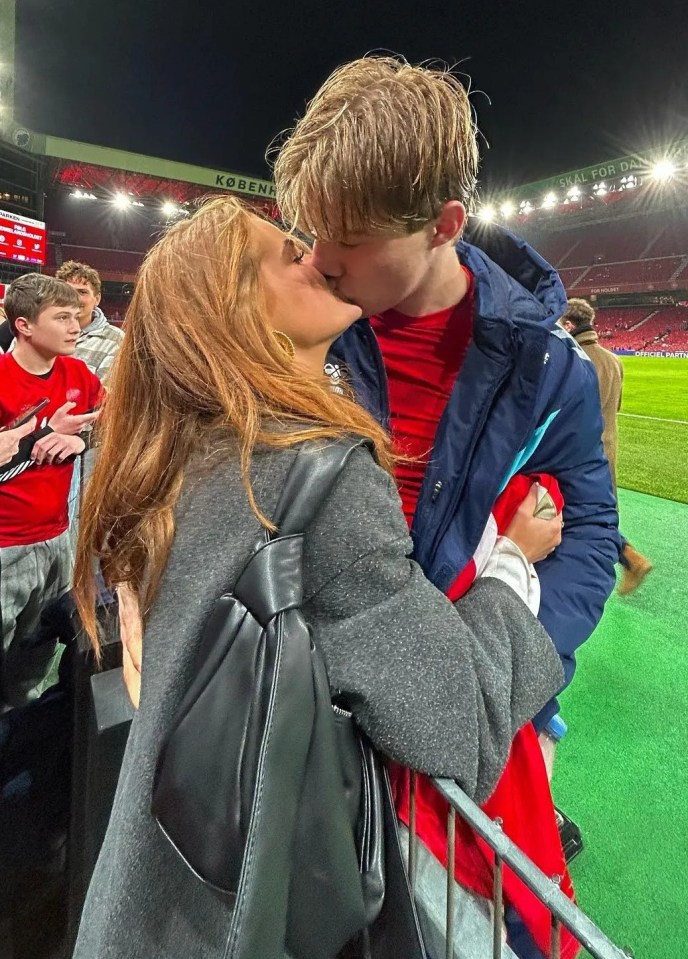 Hojlund and Laura share a kiss after he starred for Denmark