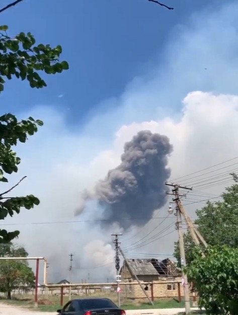 A huge plume of smoke rises after drones allegedly hit an oil depot and airfield