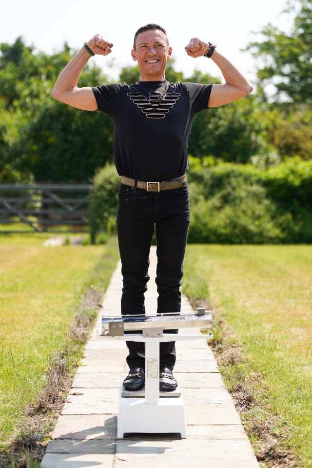 Dettori stands on weighing scales that are to be put up for auction at his home in Newmarket, Suffolk