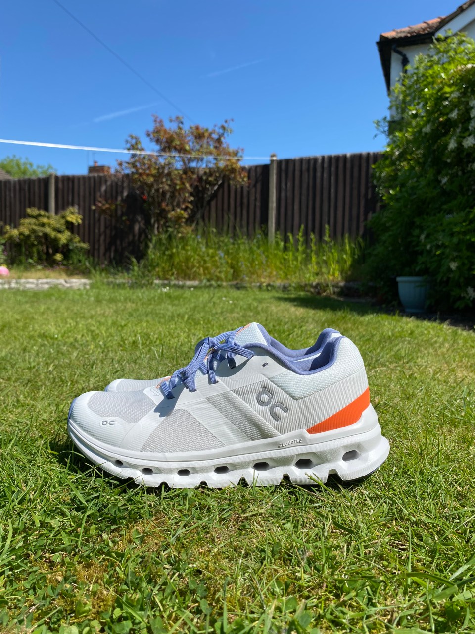 Pair of On Cloud running shoes on grass.