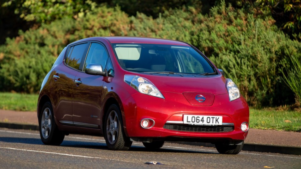 Woburn,Beds,UK. Oct 22nd 2022. 2015 red electric Nissan Leaf car driving on an English country road