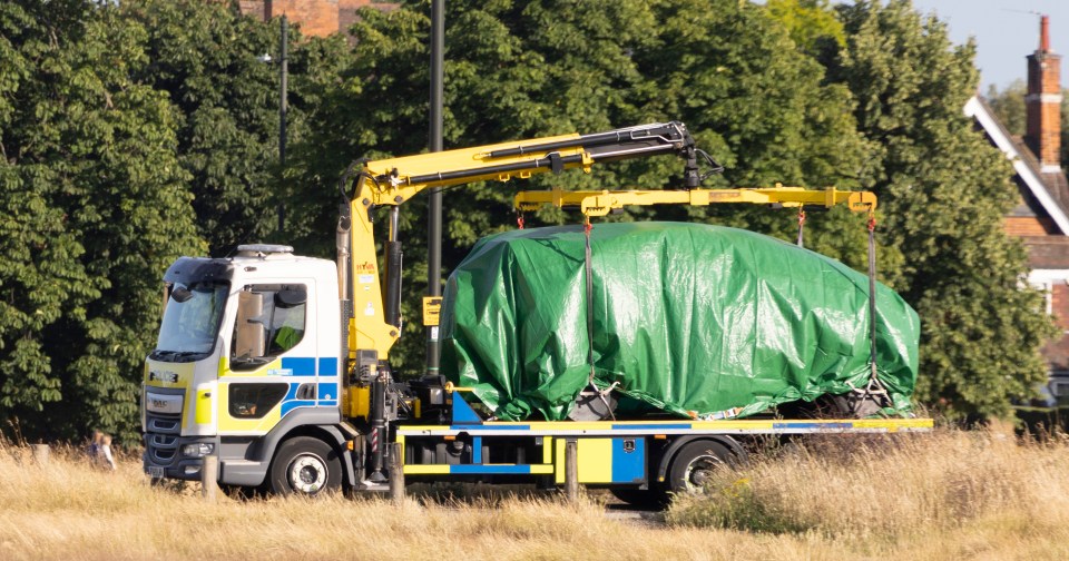 The land rover that smashed into the playground is hauled away on Thursday evening